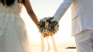 Two couple have bouquet at the sunset beach